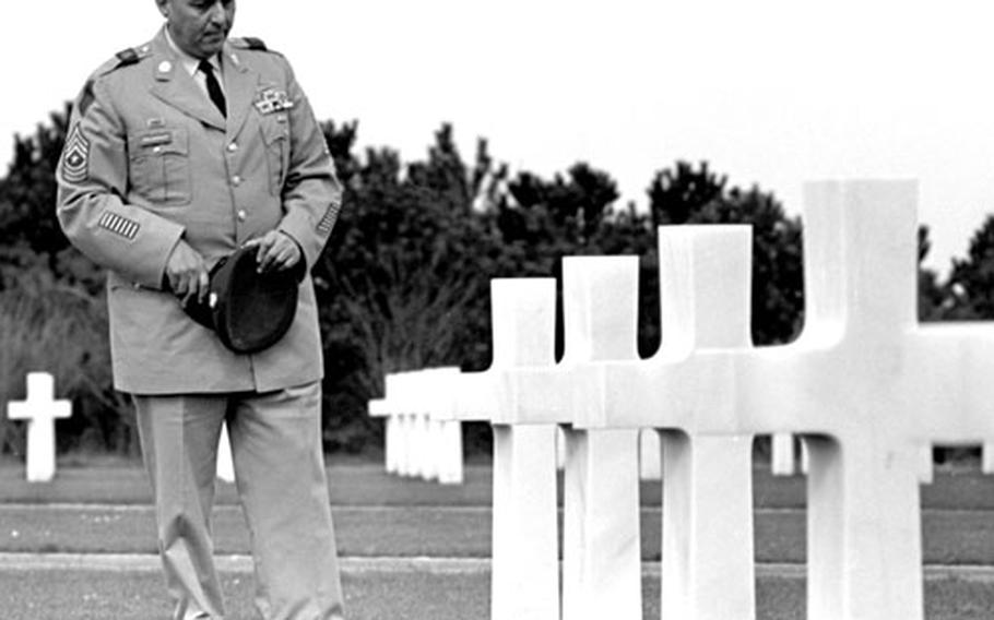 Polnoroff pauses at the grave of a buddy killed on D-Day.