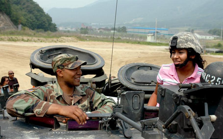 Tania Foster scopes out the view from an armored vehicle. Foster started the non-profit organization, Dallas is Love, to raise awareness and support troops stationed in South Korea.