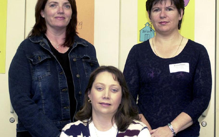 Wetzel parents, standing left to right, Pam McGuire and Hayley Reese, and Valerie Rene, seated, credit literacy coach Jacqui Gustaferro not just with making their children better readers, but helping make parents feel part of the educational process.