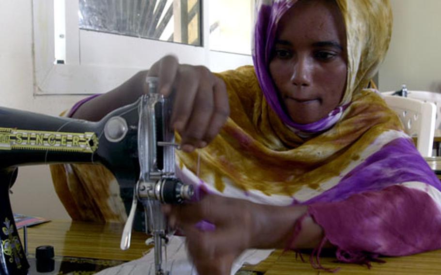 A girl from one of the poor districts in Djibouti learns how to sew, part of a program designed to give young women job skills.