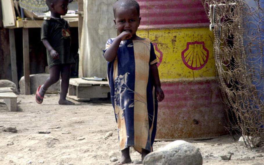 A pair of young children wander through a tenement settlement known as Arhiba, in Djibouti city.