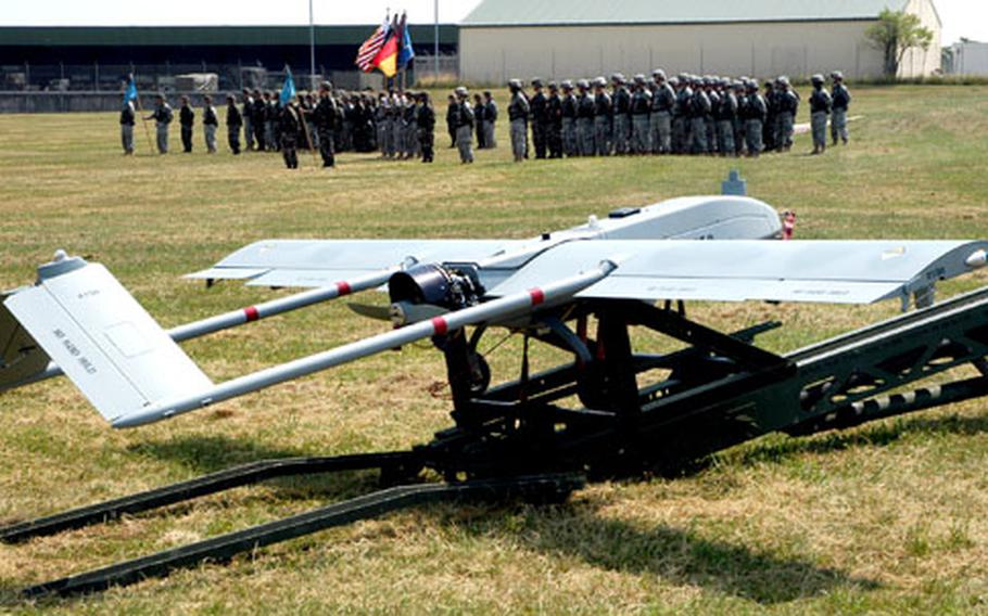 Members of Company C, 501st Military Intelligence Battalion stand on the McCully Barracks parade ground during a send-off ceremony for their 2nd and 3rd Tactical Unmanned Aerial Vehicle platoons Wednesday. The two platoons, deploying to Iraq, will be operating Shadow TUAVs like the one seen here.