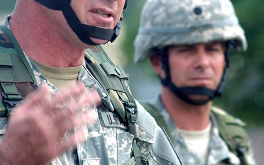 Col. Michael Ryan, left, 1st Armored Division assistant division commander-maneuver, speaks at the send-off ceremony. At right is Lt. Col. Timothy Faulkner, commander of the 501st.