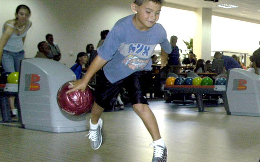 Joshua Willits, 7, bowls at the Strikers Bowling Center shortly after it opened Wednesday afternoon. Dozens of people took advantage of an afternoon of free bowling.