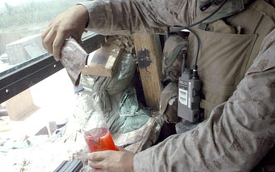 Navy Corpsman Hank Lilienthal mixes punch while on guard duty at Observation Post Omar in Iraq recently.