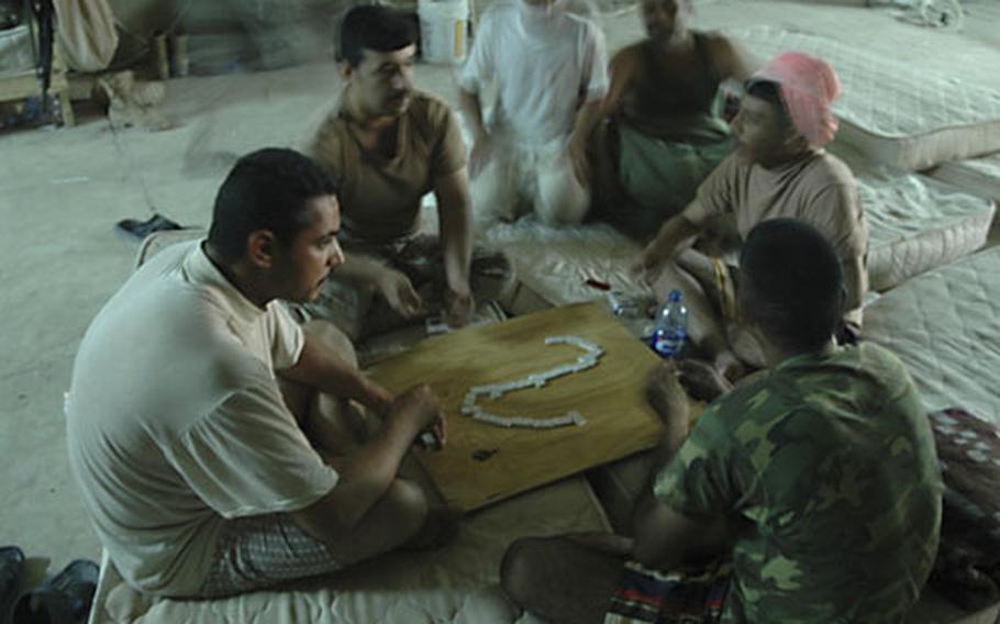 Iraqi army soldiers relax between patrols at Observation Post Omar, north of Fallujah, Iraq, recently. U.S. Marines are preparing to hand the outpost over to a battalion of the 1st Iraqi Army Division.