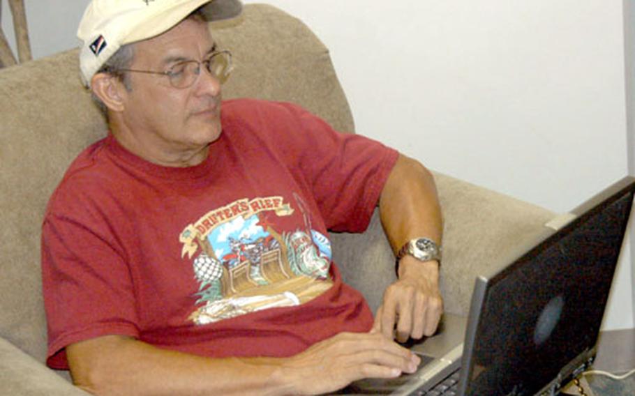 John Hall, a DC-8 flight crewmember and retired Air Force master sergeant, goes online while relaxing Saturday in the Kanto Lodge’s main lobby at Yokota Air Base, Japan. Wireless Internet access became available last week, and there are plans to expand the service to all rooms in the lodge.