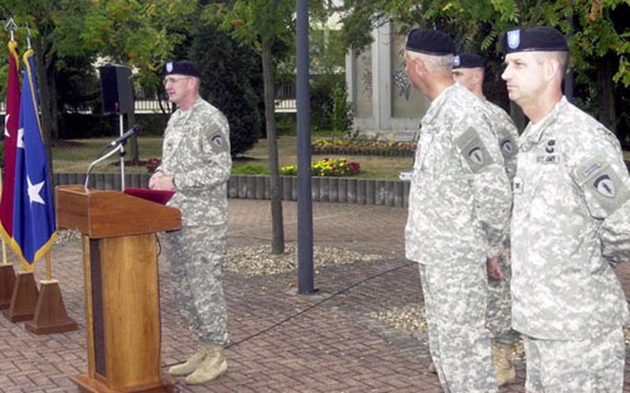 Col. David Byrn, left, the new commander of the 19th Battlefield Coordination Detachment, addresses the crowd Monday at Ramstein Air Base as Maj. Gen. Mark Hertling, center, and Col. James Waring, right, outgoing 19th BCD commander, listen.