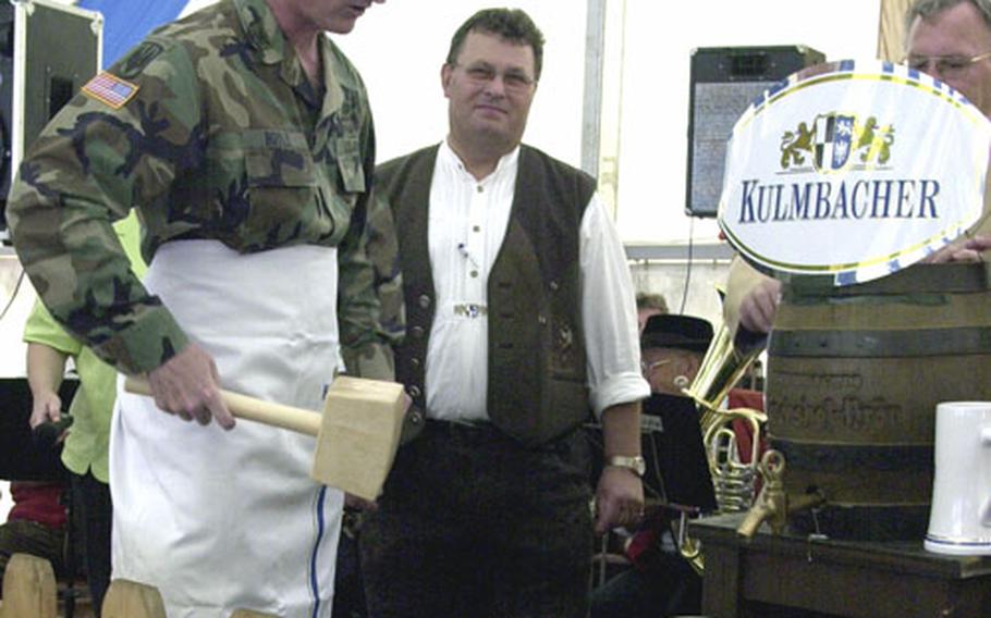 Grafenwöhr Garrison commander Col. Brian Boyle, left, prepares to tap the first keg of beer Friday at the Grafenwöhr German-American Volksfest.