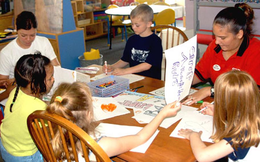 Children from Camp Adventure at Yokota Air Base, Japan, color placemats Thursday for the camp&#39;s upcoming farewell spaghetti dinner.