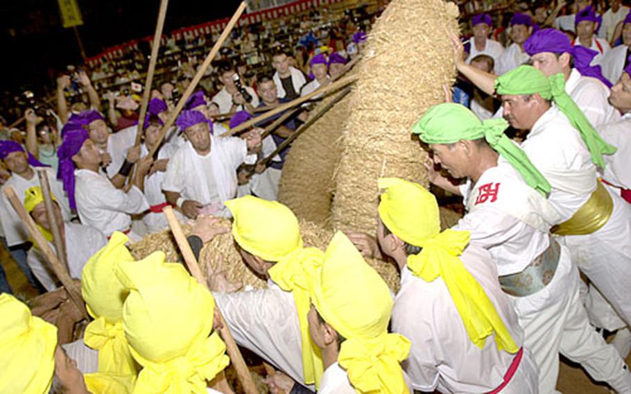 A tide of locals and Americans struggle to lift the ends of the 8-ton rope used for a giant tug-o-war Sunday in Henoko, Okinawa. It’s the culminating event of Henoko’s Giant Tug-O-War Festival, an event that occurs once every three years.