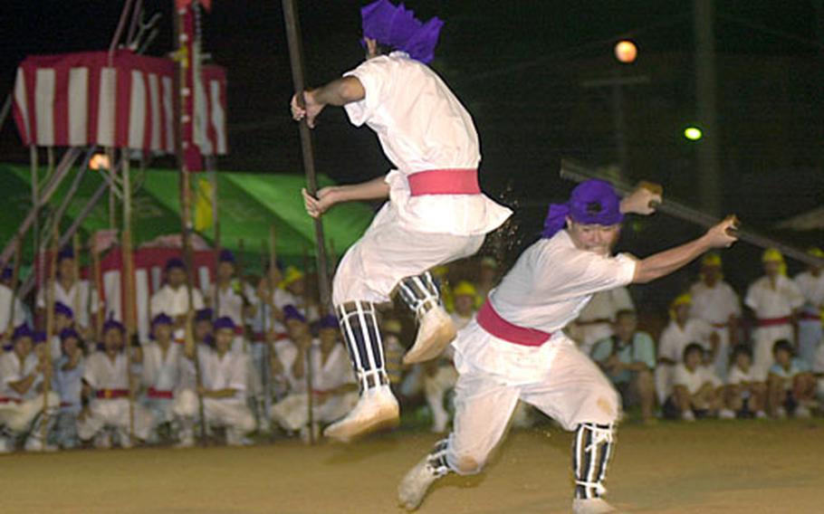 Men from a local organization demonstrate bo jitsu for a crowd of Japanese and Americans. Bo jitsu is a ceremonial martial art that uses bo, a weapon often made of Japanese hard woods or teak.