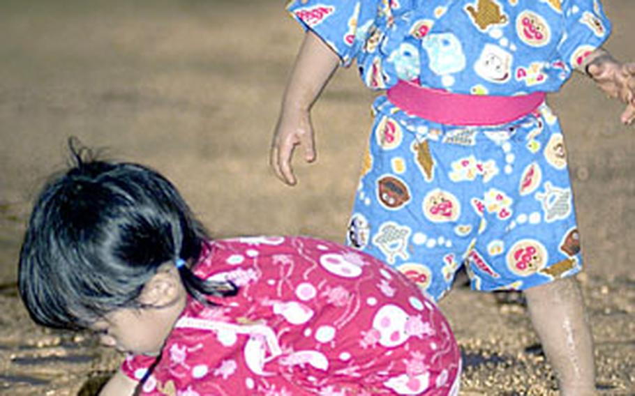 Some youngsters at Henoko Athletic Field enjoyed playing in the mud more than other events.