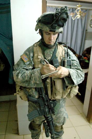 Capt. Matthew Graham, 28, of Midwest City, Okla., takes notes during a census patrol in western Ramadi recently.