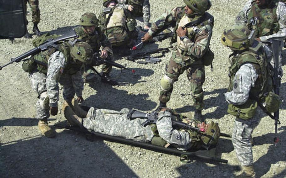 596th Maintenance Company soldiers practice evacuating casualties at Grafenwohr, Germany, on Thursday in preparation for deployment to Iraq next month.