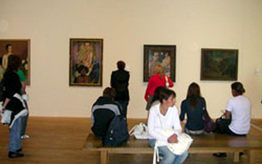 Visitors to the Tate Modern museum in central London take in the art.