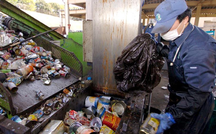 A Japanese worker separates garbage at the Recycling and Incinerator Plant on Yokota Air Base, Japan.