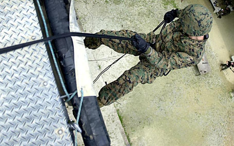 3rd MRB Lance Cpl. Louis Ocampo, 19, from New York, with 3rd Materiel Readiness Battalion, steps off the lip of the skid at the Jungle Warefare Training Center Thursday.