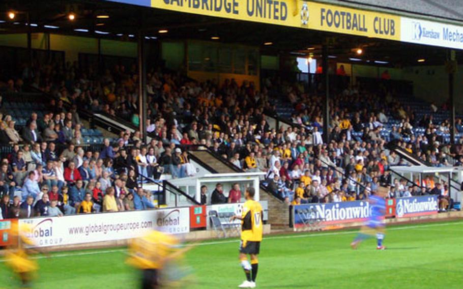 Cambridge United Football Club players rush to defend a throw in during a recent game at Abbey Stadium.