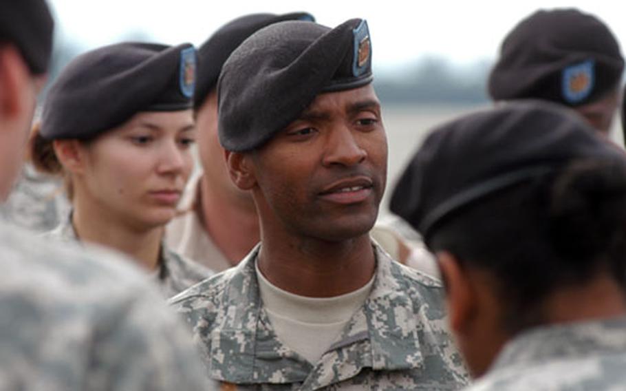 Staff Sgt. Christopher Dulaney, 34, a platoon sergeant from Cleveland, addresses the troops of the 596th Maintenance Company after Friday’s farewell ceremony.