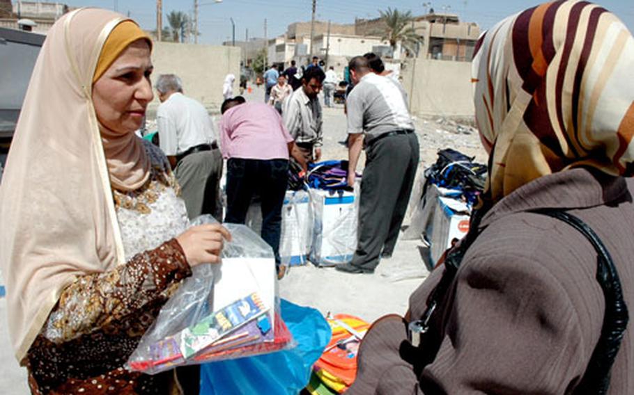 Hurriyah Mohammed, who runs a girls&#39; school in Shab, picks up a new generator and some school supplies Monday.