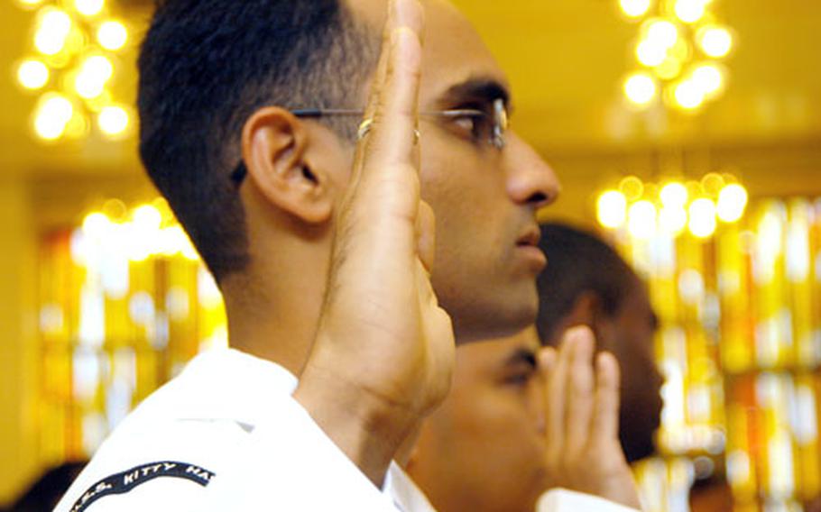 Petty Officer 2nd Class Syed Yawar Abbas, from the USS Kitty Hawk, took the oath of allegiance at a U.S. naturalization ceremony at Yokosuka Naval Base on Friday. Abbas is from Pakistan.