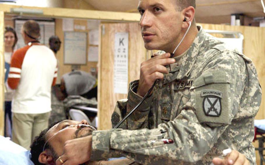 Dr. (Maj.) Chris Lettieri checks Martin Foley, who had been rushed to the 14th Combat Support Hospital on Bagram Air Base, Afghanistan, after complaining of chest pains.