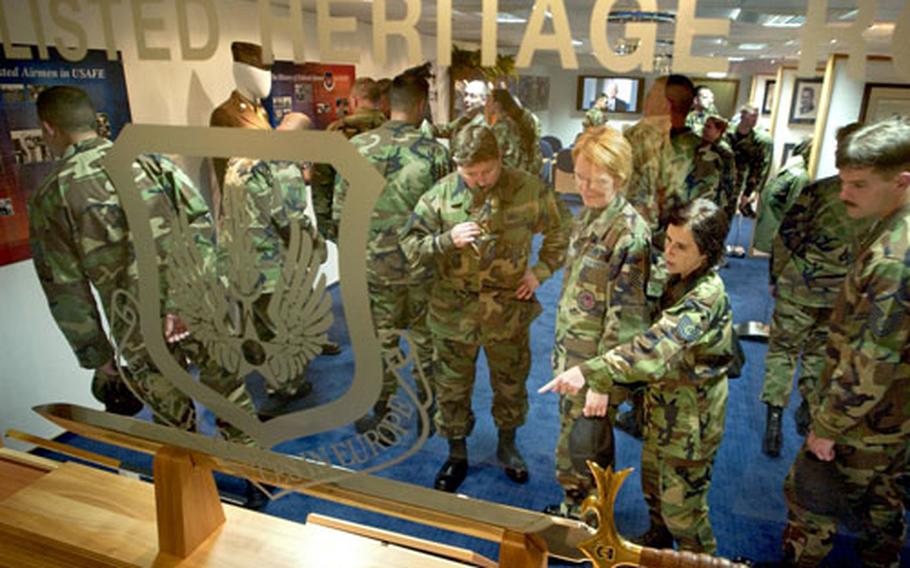 Students from a local Non Commissioned Officers Academy class look at items on display in the new Parish Enlisted Heritage Room located in the USAFE Headquarters building at Ramstein Air Base.