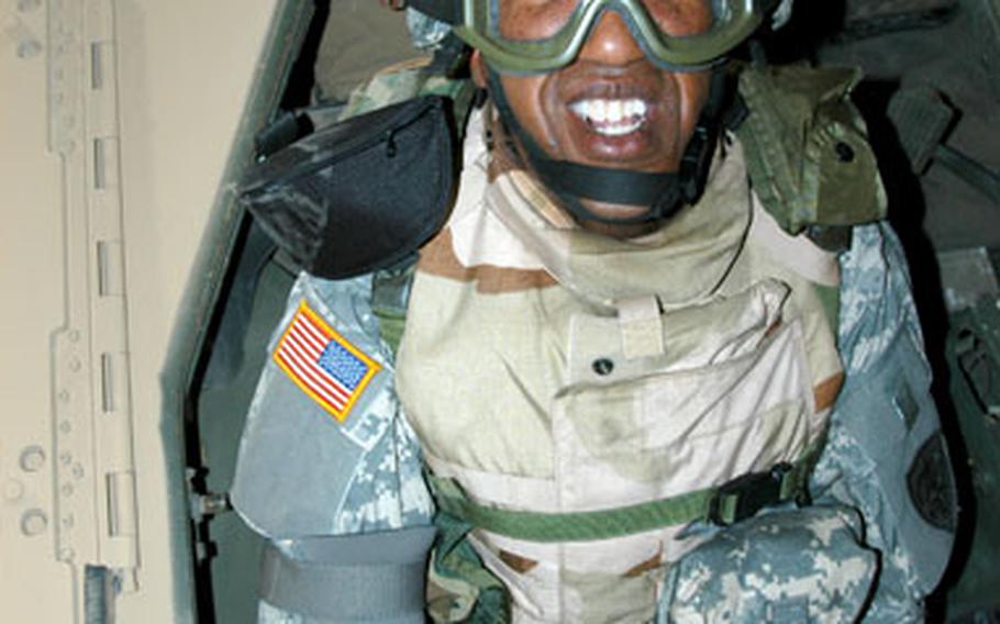 Army Lt. Col. James Morehead, 3rd Personnel Command at Camp Arifjan, Kuwait, flashes a smile after emerging last week from the Humvee rollover simulator.