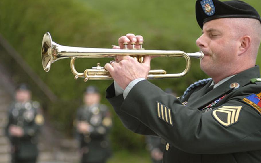 Staff Sgt. Karl Skelton plays taps at the end of a memorial ceremony held in honor of Cpl. Luis Tejeda at the Baumholder Chapel on Thursday.