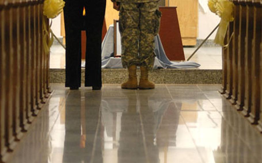 Col. David Hogg, the assistant division commander-support, pays his respects to Cpl. Luis Tejeda.