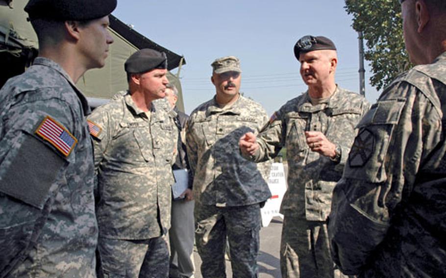 U.S. Forces Korea commander Gen. B. B. Bell, right, talks Friday afternoon to local commanders about evacuation plans for families and pets should an emergency arise in South Korea.