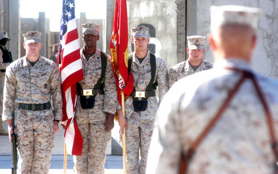 The 1st Marines Logistics Group color guard stands at attention before group commander Col. David M. Richtsmeier on Friday at Camp Taqaddum, Iraq, during the celebration of the 231st birthday of the U.S. Marine Corps.