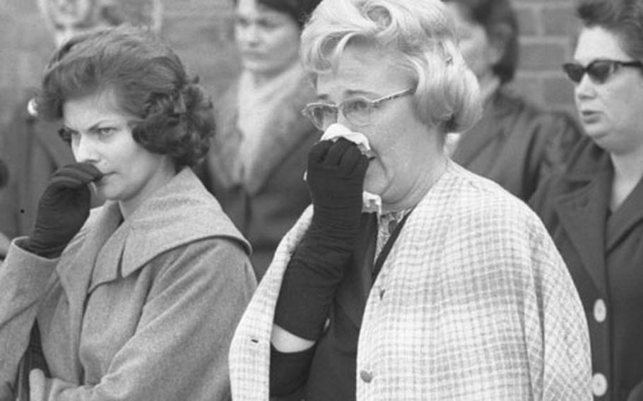 Americans in Darmstadt, Germany, listen to the announcement of President Kennedy's death.