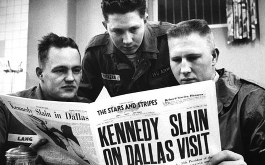 Troops in Darmstadt, Germany, read about President John F. Kennedy's death.