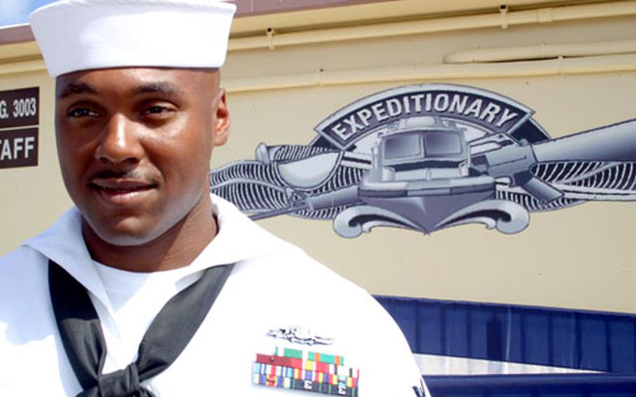 Petty Officer 2nd Class Carl Hurtt, a master-at-arms with Mobile Security Squadron 7 at U.S. Naval Base Guam, was the first sailor to complete the Navy’s new Expeditionary Warfare program. He received the Expeditionary Warfare device he’s wearing — seen larger on the wall behind him — at a ceremony Friday.