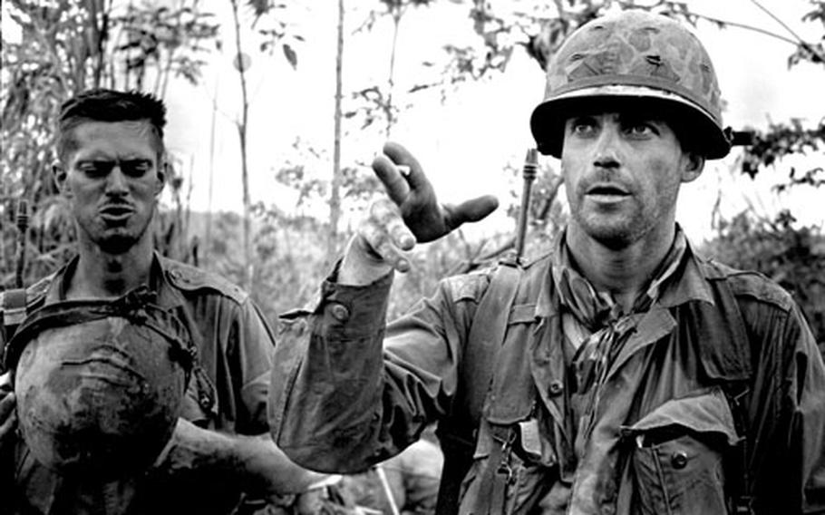 Capt. William Carpenter, right, talks about how his company fought its way out of near-encirclement by North Vietnamese troops near Kontum. At left is 1st Lt. William Jordan.