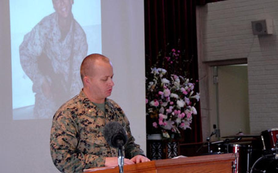 Maj. Ken Quiner pauses to collect himself Tuesday while speaking at a memorial service for Cpl. Jennifer Parcell. He said Parcell was a Marine "who understood the big picture" and knew the "value of her service."