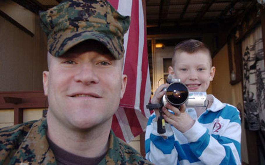 Marine Maj. Neil Murphy and his 9-year-old son, Jake, are seen recently outside their home at Yokota Air Base, Japan. Jake is among 20 kids who will be featured in a reality series called "My Life As a Child" on The Learning Channel. The program debuts Feb. 26 in the United States. The episode featuring Jake is due to air March 12.