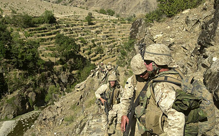 Marines with 2nd Battalion, 3rd Marine Regiment, begin climbing a 7,000-foot mountain in eastern Afghanistan in September 2005.