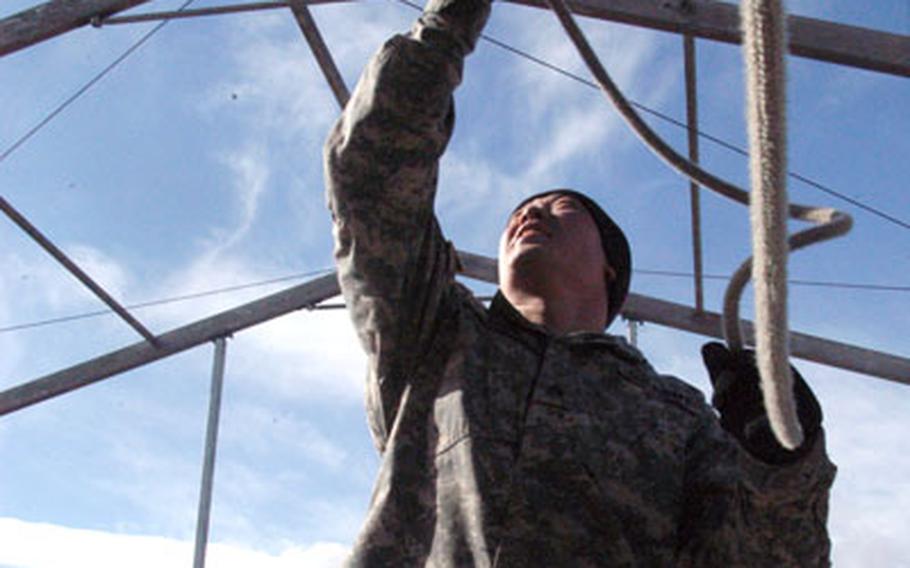 Sgt. Mike Tobin, of Headquarters and Headquarters Company, 1st Battalion, 37th Armor Regiment, 1st Brigade Combat Team, wrangles a rope Wednesday that will raise a sheath of canvas on a large fest tent at the site for the brigade&#39;s reception. Though funding for big welcome-home bashes has been slashed by the Army, the brigade, with help from other units and donated time by civilians and schoolchildren, has found ways around the funding shortage and will throw a party Tuesday that is almost as big as former blowouts at a fraction of the cost.