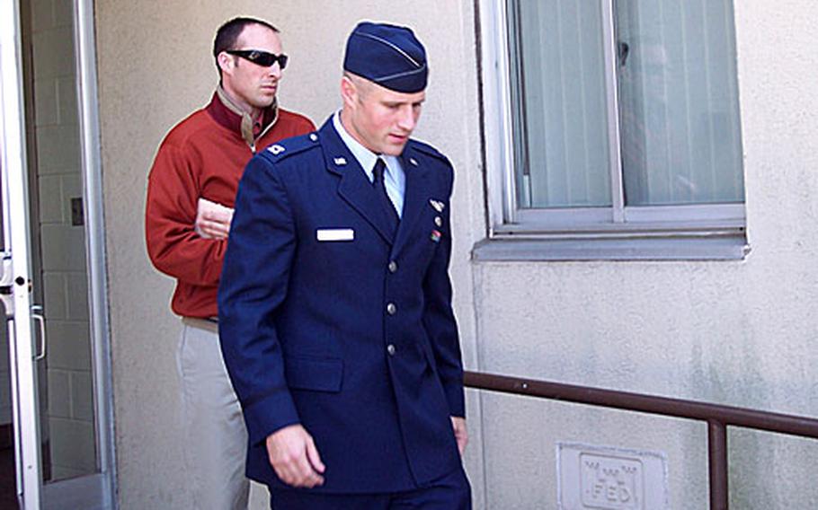Capt. David T. "Tom" Still, in dress uniform, leaves the courtroom at Kunsan Air Base Wednesday following testimony from one officer who says Still raped her, and another who says he attempted rape. Still pleaded not guilty to the rape charges, but pleaded guilty to having sex with an enlisted female on Tuesday.