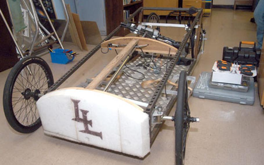As part of his global-warming instruction at Lakenheath High School, Garrett Billington also manages the Green Power race team, which is comprised of students who build and race an electronic vehicle like the one seen here. The vehicle can reach speeds of 48 mph using a wheelchair motor without giving off any pollution, Billington said.