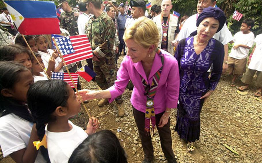 U.S. Ambassador to the Philippines Kristie Kenney greets schoolchildren on Jolo Island during a visit Saturday. Kenney was among a group of visitors to tour a site where U.S. troops have treated patients, built roads and renovated schools as part of Balikatan 2007.