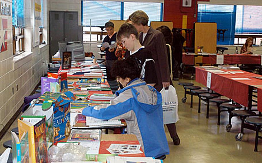 Home school families browse an assortment of educational materials on display at the Korea Home School Conference on Saturday at Seoul American Elementary School.