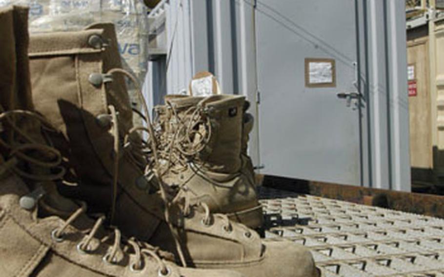 A row of combat boots are left behind after the Navy divers leave the platform of Ocean 6, a barge attached to the Khawr al Amaya Oil Platform in the Persian Gulf.