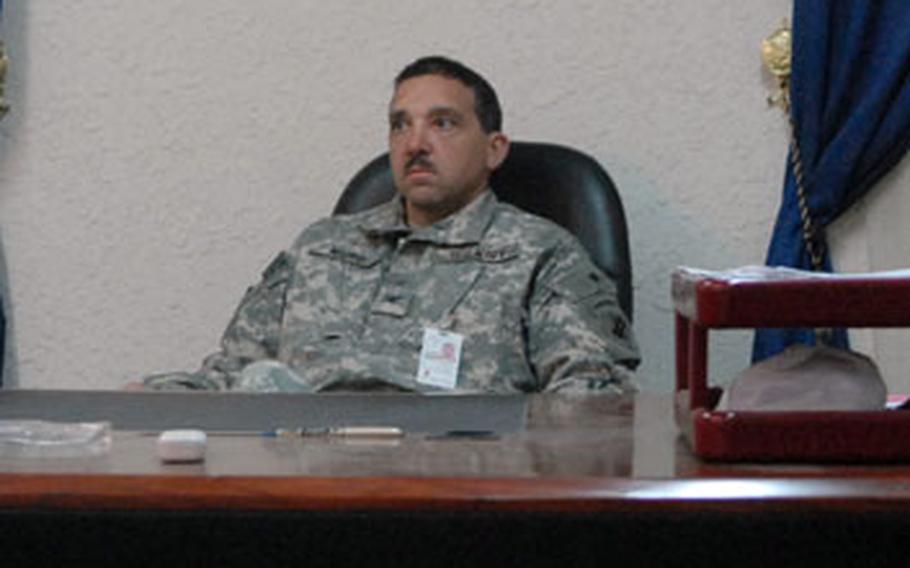 Navy Capt. Bob Muro, deputy leader of the Provincial Reconstruction Team in Kirkuk, handles much of the day-to-day operations of the group. He is sitting in his office preparing himself for a day of meetings in the Kirkuk Government Building on March 4.