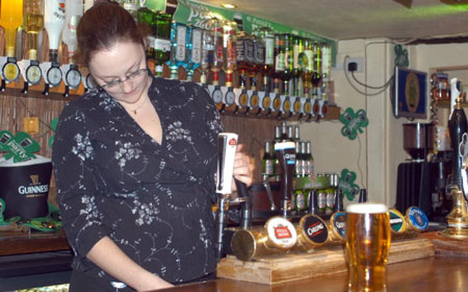 Dog & Partridge bartender Hayley Cockayne pours a couple of cold pints at the pub in Bury St. Edmunds.