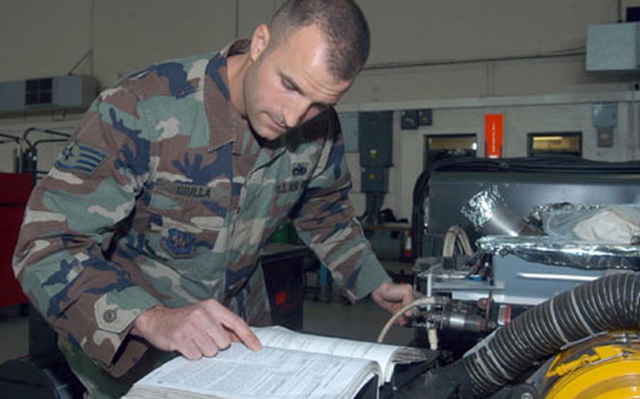 Staff Sgt. Joseph Ciulla, from the 100th Maintenance Squadron, refers to a manual as he inspects a gas turbine compressor. The Cleveland native said he was heading down the wrong path as a youth, so he joined the Air Force. Nine years later, he became Mildenhall&#39;s NCO of the Year.