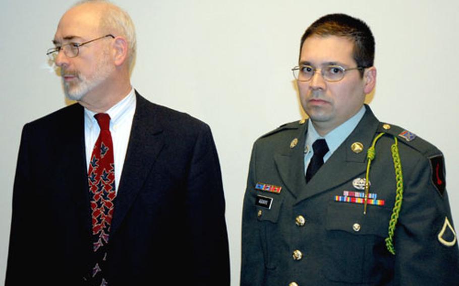 Defense counsel David Court and Spc. Agustin Aguayo before a post-trial press conference.